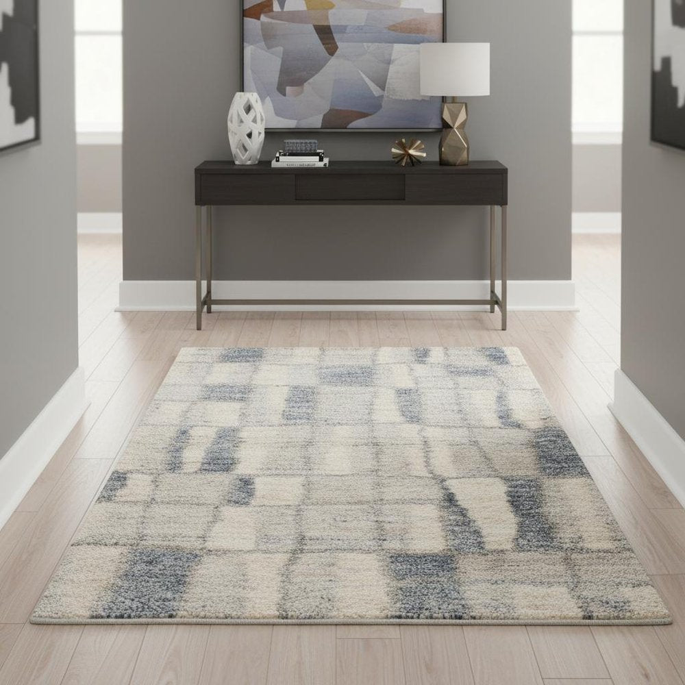 5' X 8' Ivory And Blue Abstract Area Rug
