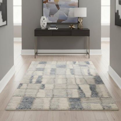 5' X 8' Ivory And Blue Abstract Area Rug