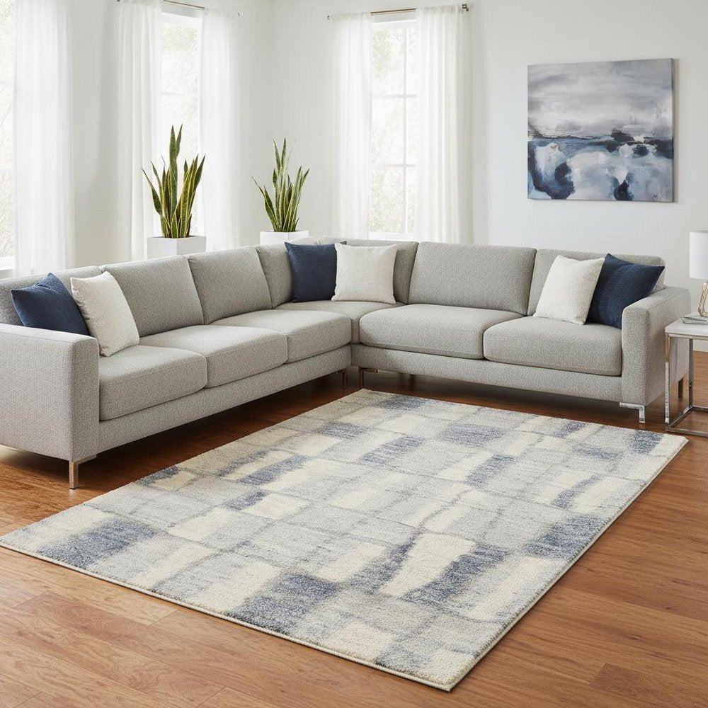 5' X 8' Ivory And Blue Abstract Area Rug