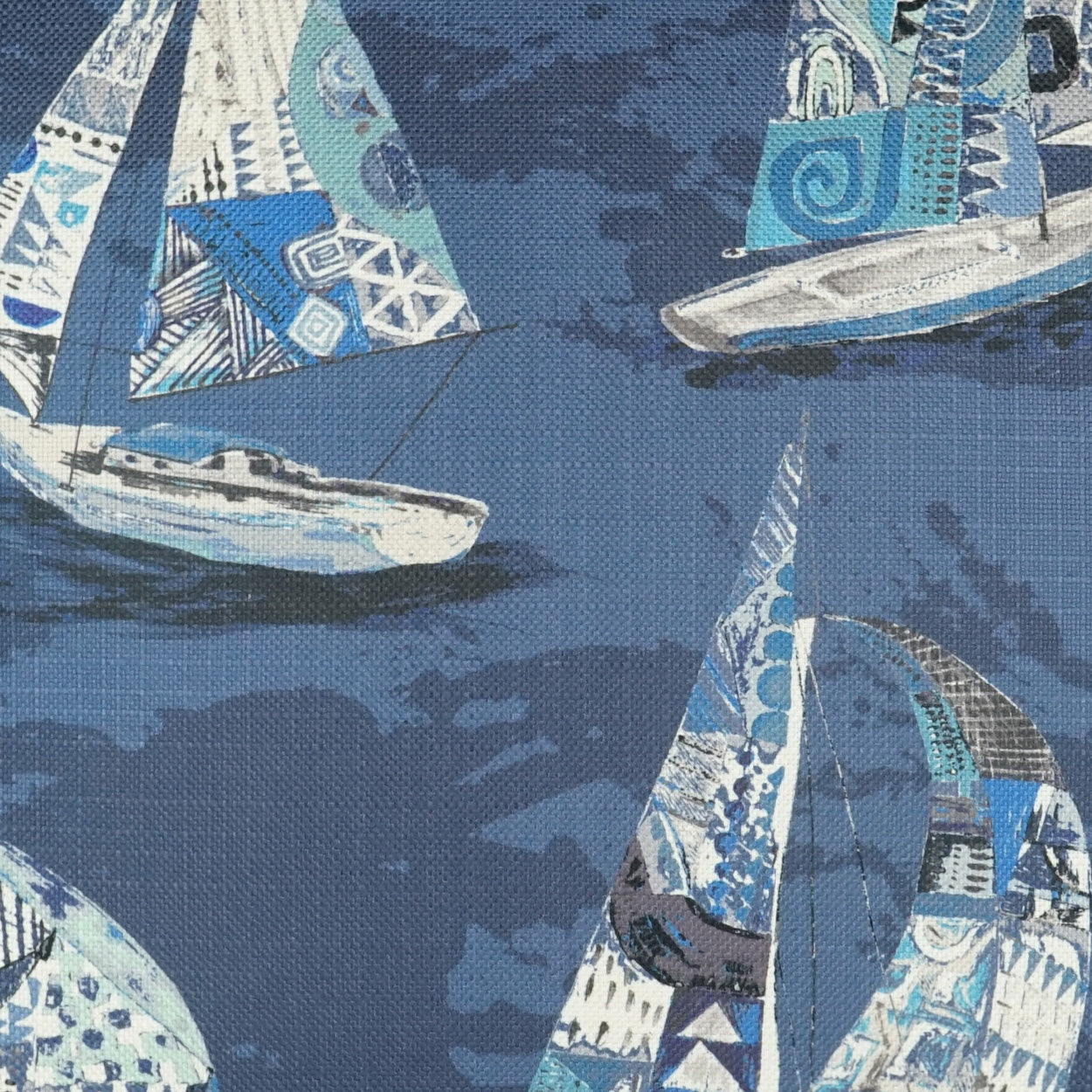 Nautical sailboat fabric print in blue and teal tones with white sails and geometric patterns; coastal textile design.