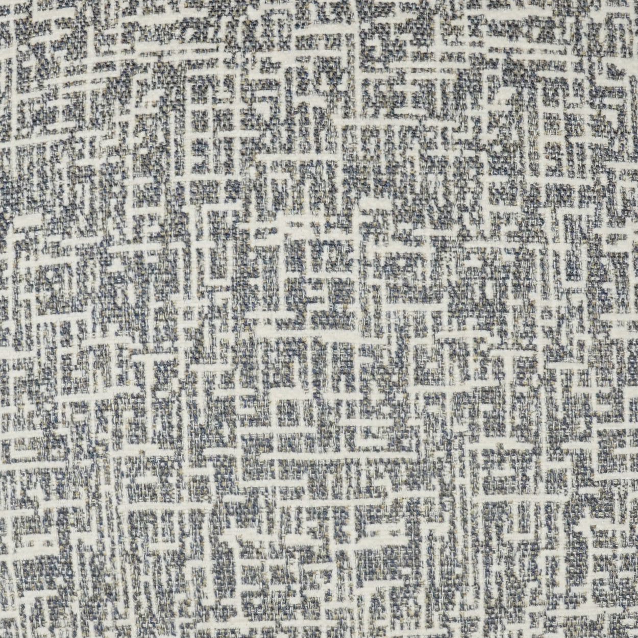 Grey and white woven fabric with a geometric maze pattern, textured upholstery textile.