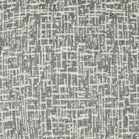 Grey and white woven fabric with a geometric maze pattern, textured upholstery textile.