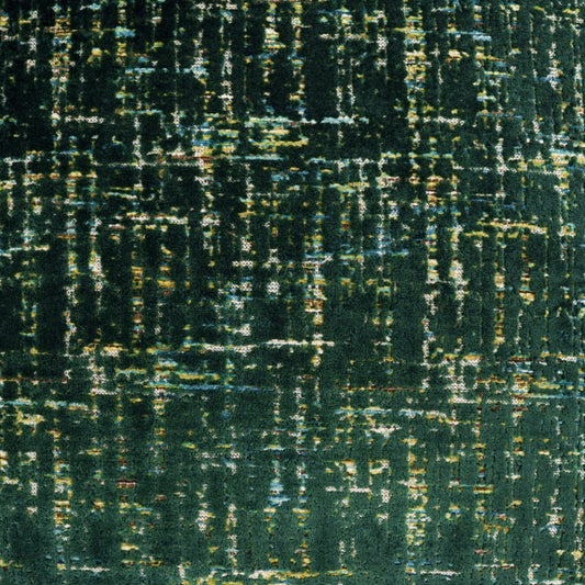 Dark emerald fabric with an abstract distressed pattern of gold, olive and teal flecks.