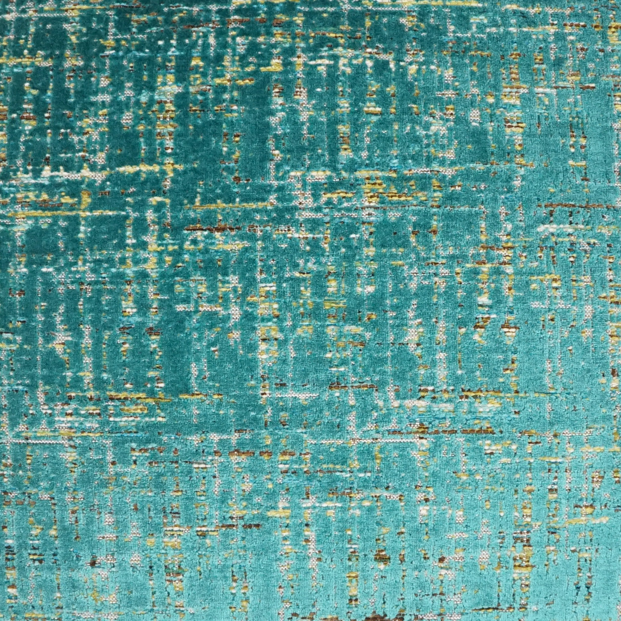 Teal fabric texture with gold metallic flecks in an abstract distressed pattern.