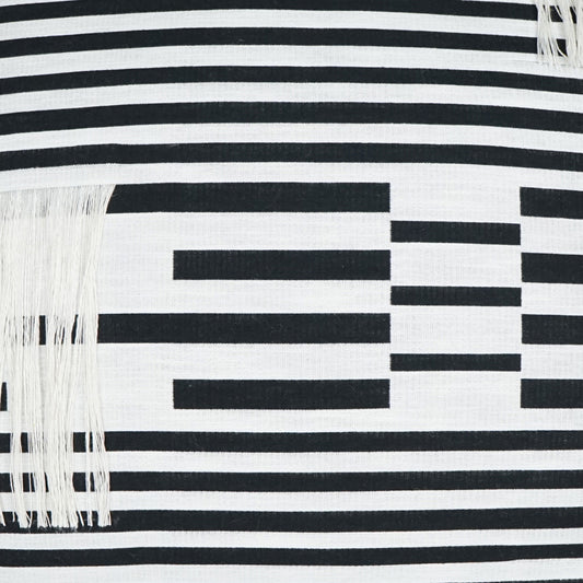 Black and white striped textile with fringe tassels and a geometric rectangular pattern across the fabric.