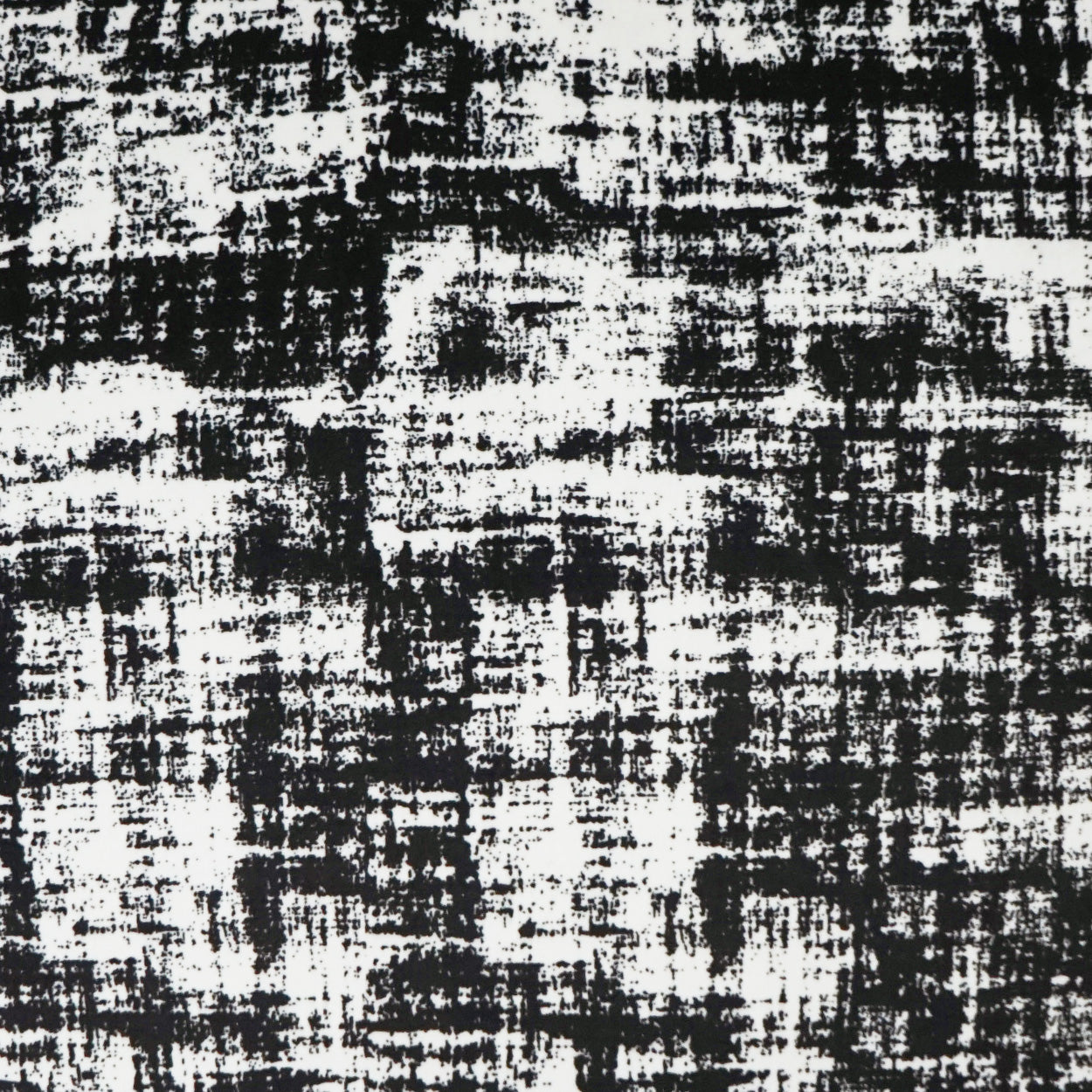 Close-up of black & white textured fabric with an abstract woven pattern; versatile for upholstery or décor.