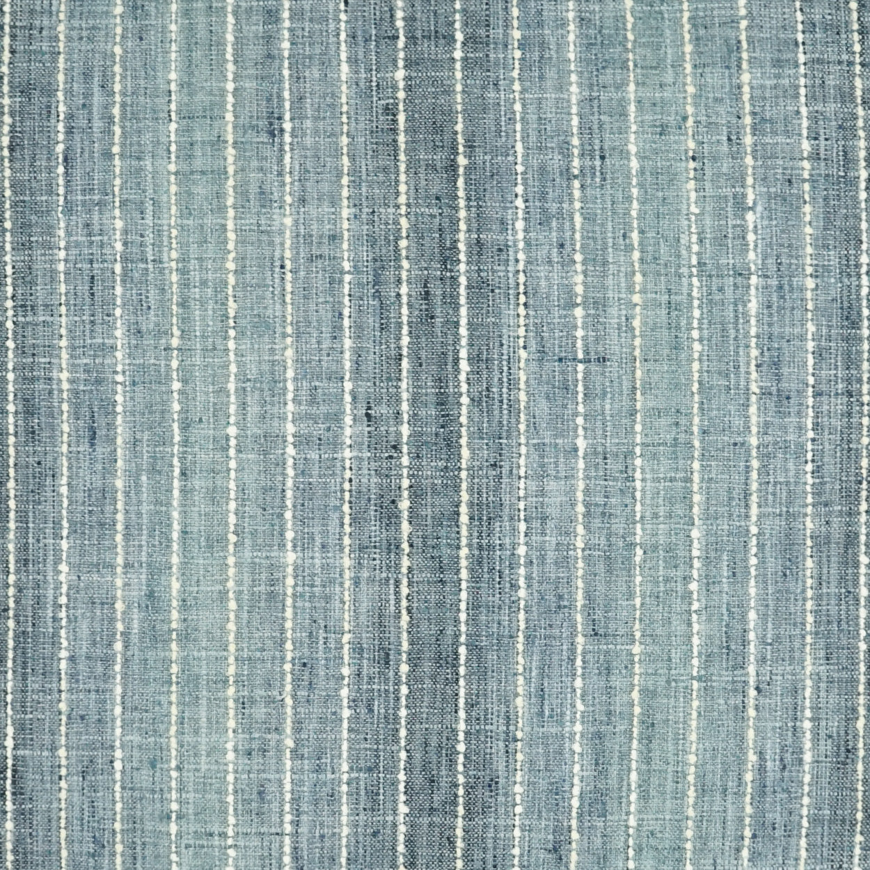 Blue denim-style striped fabric with light vertical lines; versatile for apparel or upholstery.