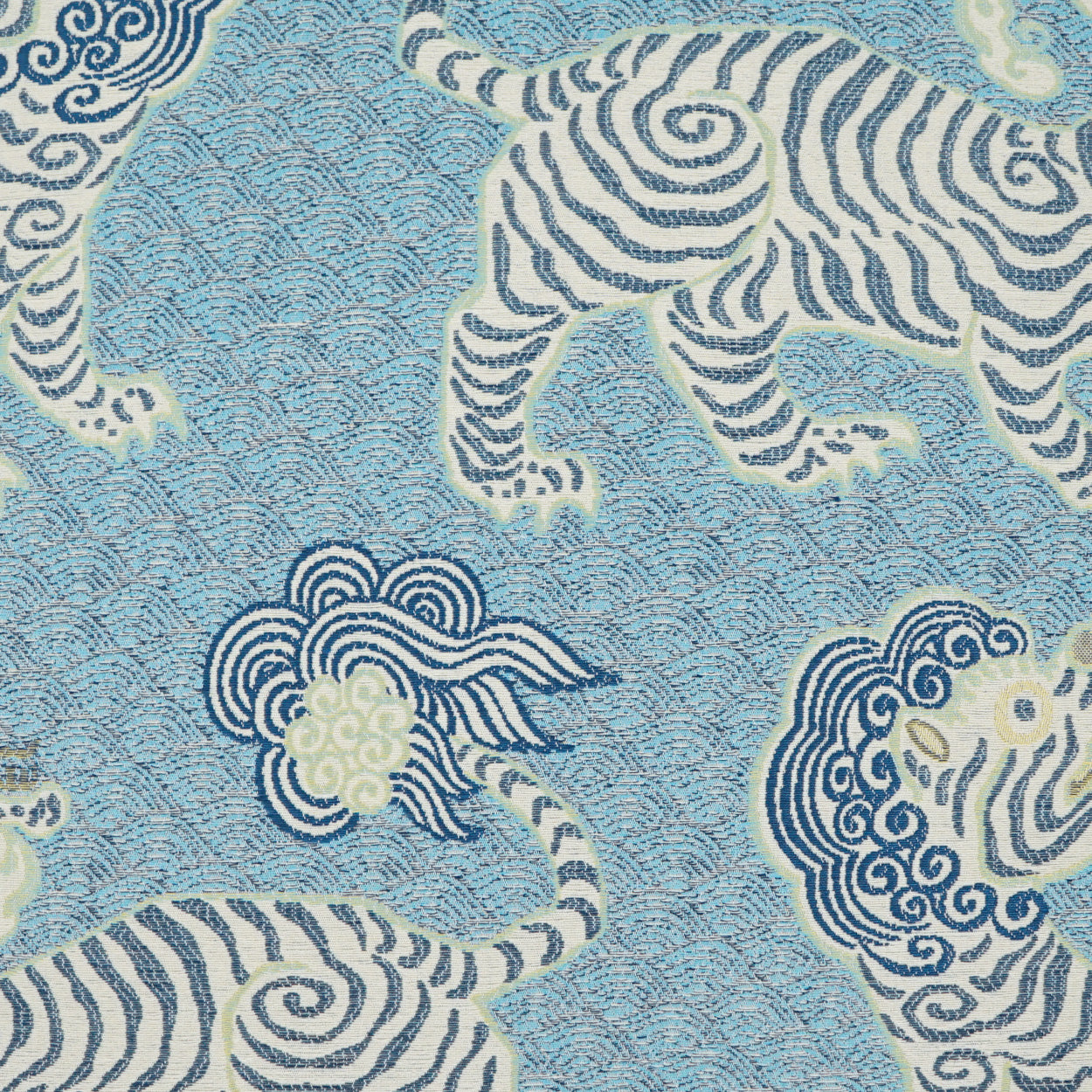 Blue pillow with cream and navy zebra motifs and swirling cloud patterns; 24" x 24