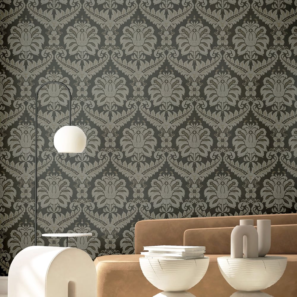 Living room with anthracite traditional damask wallpaper, tan sofa, arc floor lamp with a white globe shade, and white bowls and vases.