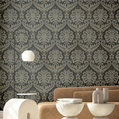 Living room with anthracite traditional damask wallpaper, tan sofa, arc floor lamp with a white globe shade, and white bowls and vases.