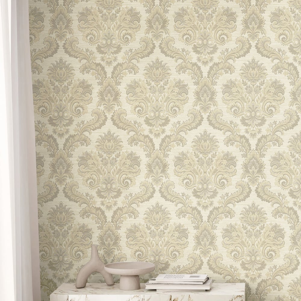 Beige damask wallpaper with ornate floral pattern; white pedestal holds a pale ceramic vase and a small stack of magazines.