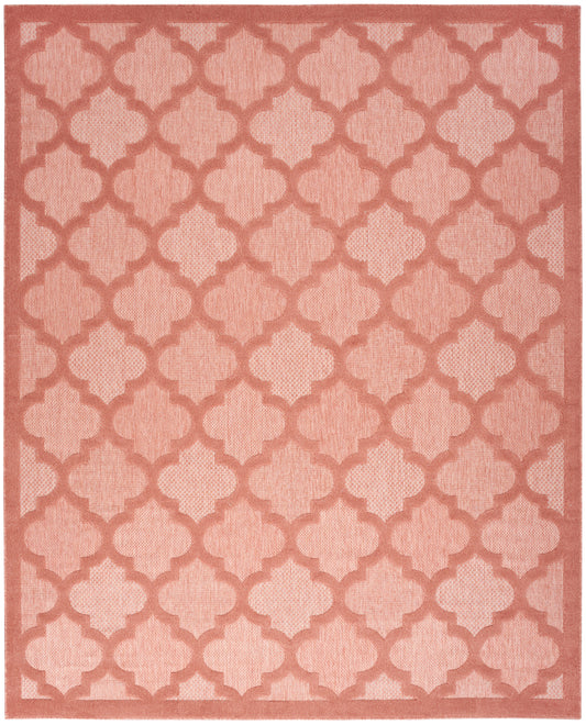 Salmon-pink area rug with lighter pink trellis quatrefoil lattice and border, soft woven texture.