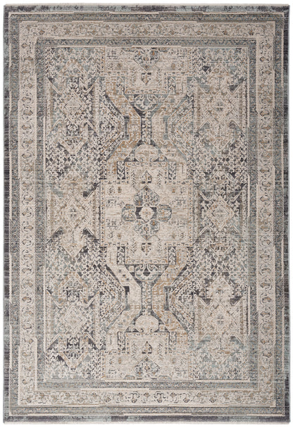 Rectangular distressed vintage rug with geometric central medallion, ivory, beige, gray and blue tones, ornate border.