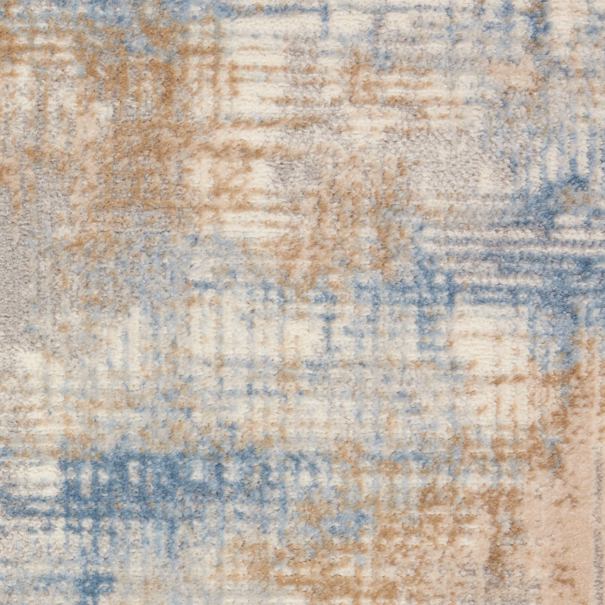Abstract 10' runner rug in beige, tan and light blue with a distressed patchwork pattern and plush texture.