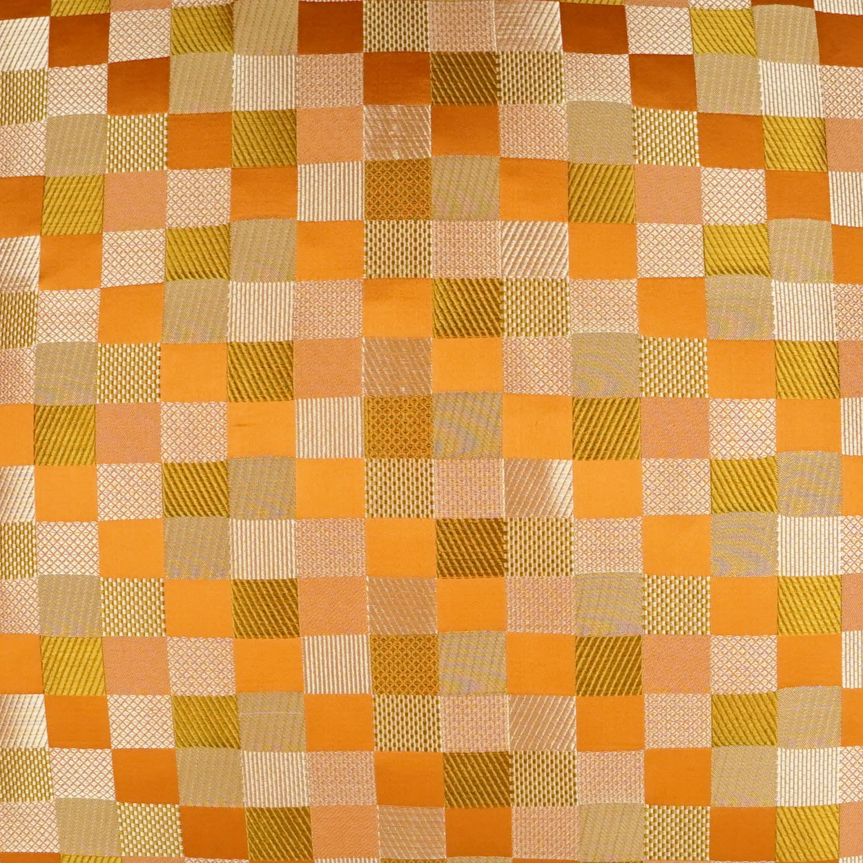 Orange, peach, beige and olive plaid pillow with a check pattern, 24" x 24".