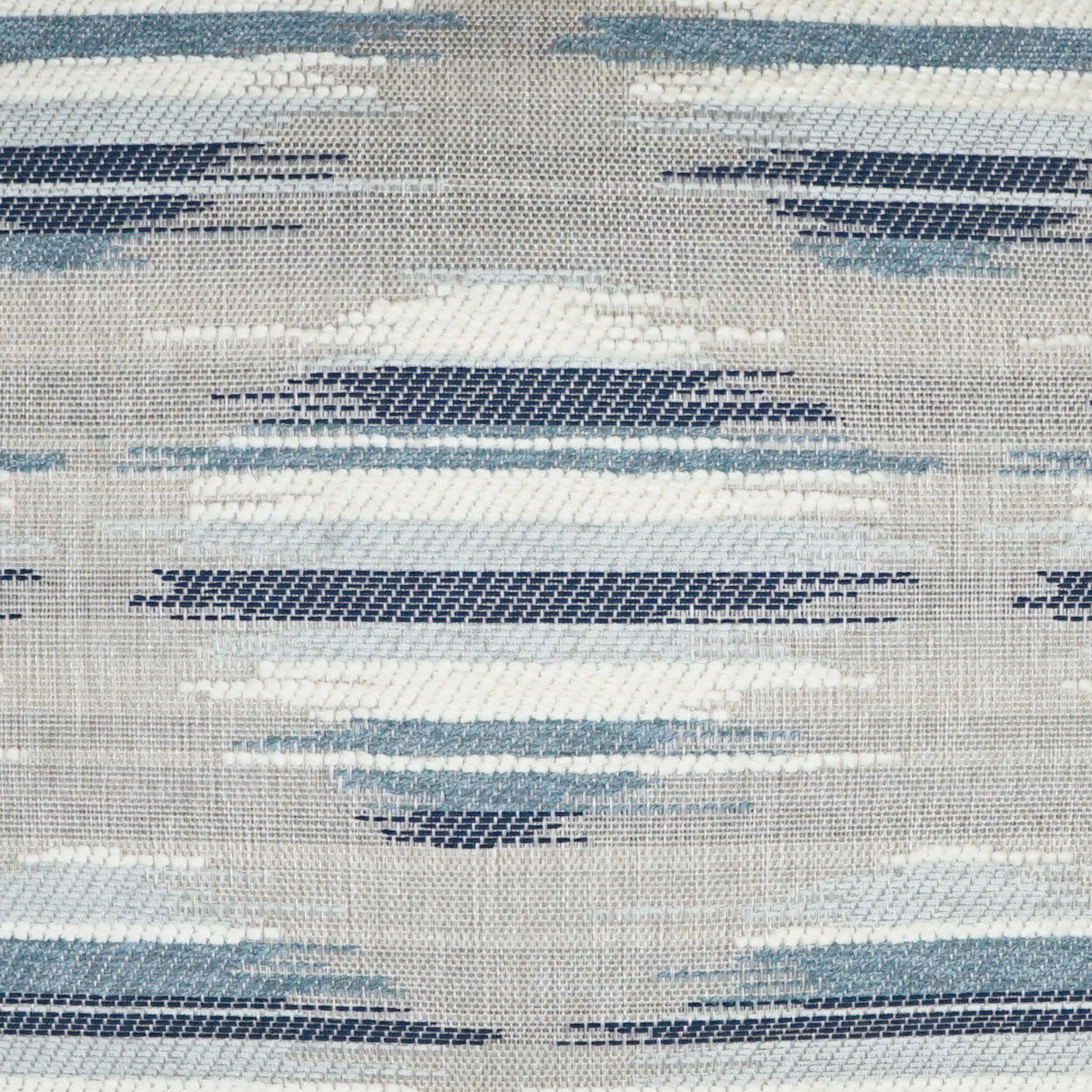 Woven fabric with geometric blue and navy oval stripes on beige background; textile pattern.