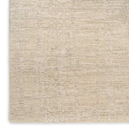 Beige modern area rug with subtle textured geometric pattern; soft plush pile for living room decor.