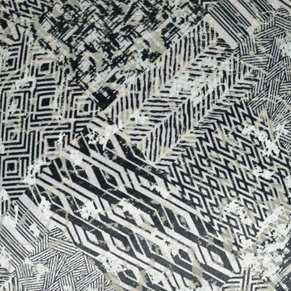 Monochrome woven pillow with black, white & gray geometric patterns, including chevrons and diamonds (24 x 24 inches).