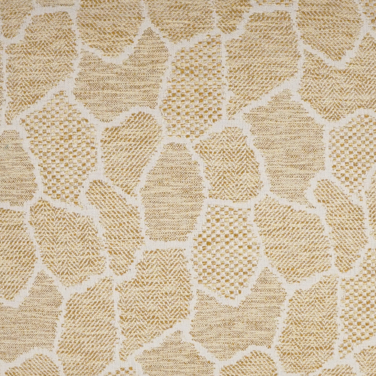 Beige fabric with irregular tan stone-like blocks in a mosaic giraffe-print pattern; woven texture.