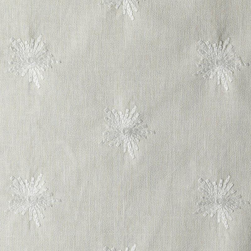Ivory upholstery fabric with white embroidered starburst motifs and subtle texture; versatile home decor textile.