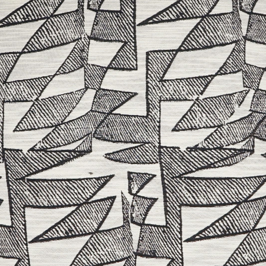 Cream fabric with repeating black angular geometric leaf shapes and crosshatched shading.