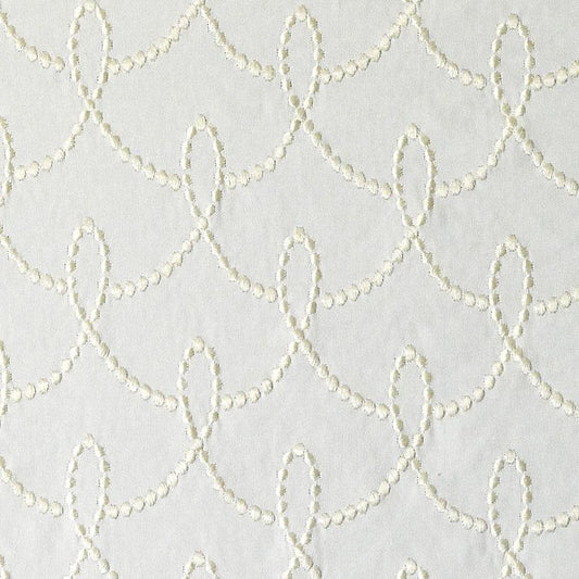 Cream chain-stitch embroidery on white upholstery fabric forming a repeating scalloped loop pattern; textured fabric.