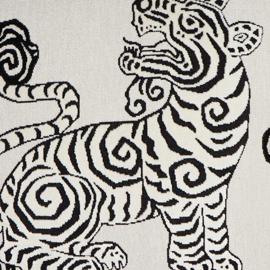 White fabric with bold black zebra print featuring swirling, curved stripes and stylized zebra figures.