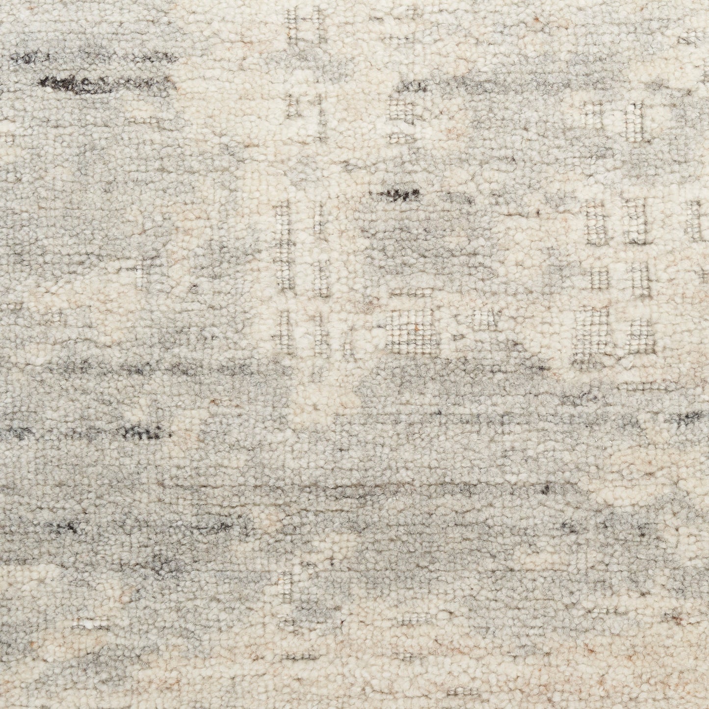 Cream and gray abstract area rug with soft texture and distressed geometric pattern.