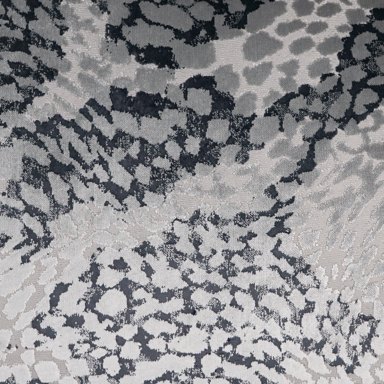 Grayscale leopard print fabric in black, charcoal, and light gray; soft textile for apparel or decor.