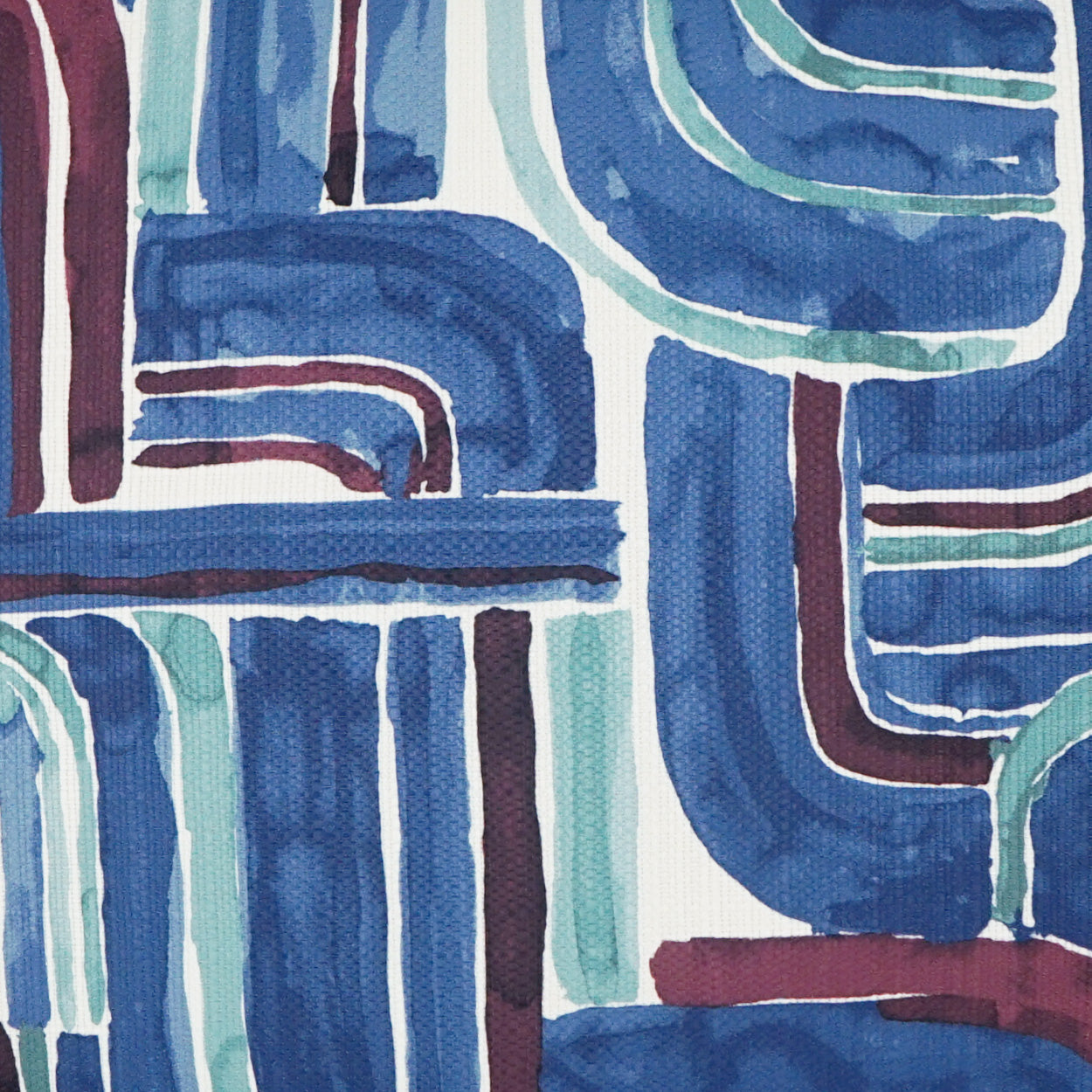 Abstract geometric fabric pattern in blues, teals and burgundy with bold curved lines.