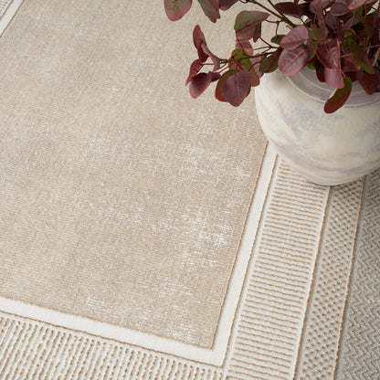 Beige rectangular rug with white border and textured surface, shown with a white ceramic planter holding burgundy leaves.