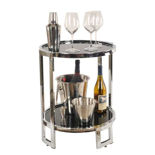 Polished chrome two-tier bar cart with shaker and three wine glasses on top; bottom shelf with ice bucket, bottle and tongs.