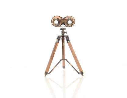 Vintage brass binoculars on a wooden tripod stand, antique-style desk display.