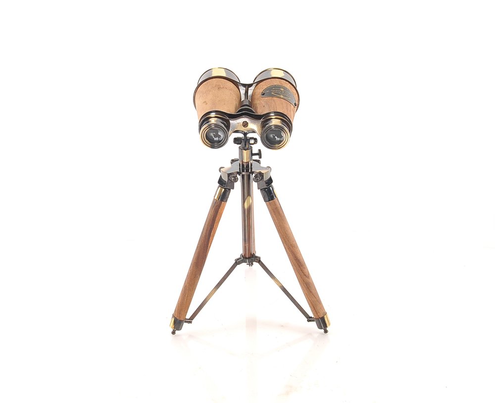 Vintage brass & wood binoculars on a three-legged wooden tripod.