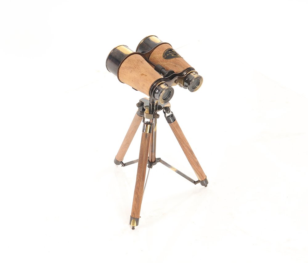 Antique wooden binoculars with brass fittings on a compact wooden tripod.
