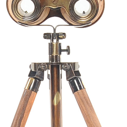 Vintage brass binoculars mounted on a wooden tripod with metal fittings.