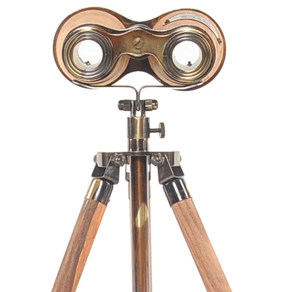 Antique brass binoculars with twin lenses mounted on a wooden tripod stand, vintage steampunk style.