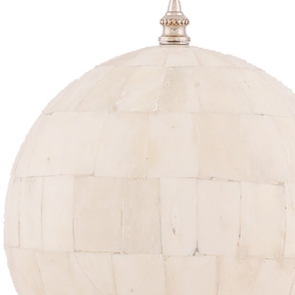 Ivory woven rattan sphere pendant light with gold metal cap and hanging chain.