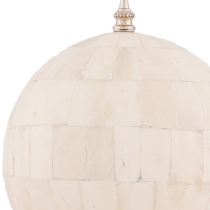 Ivory woven rattan sphere pendant light with gold metal cap and hanging chain.