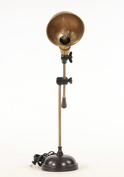 Vintage brass floor lamp with copper-toned shade, adjustable joints, black hardware, and a grey pull chain; industrial style.
