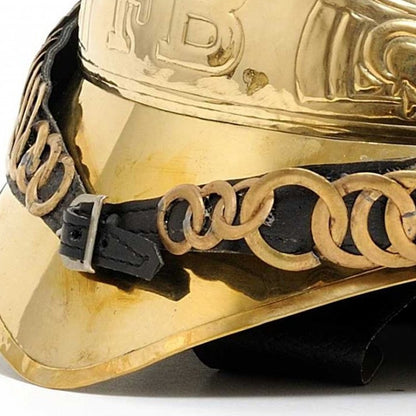 Gold metallic cowboy hat with black leather hatband and chunky gold chain-link accent.