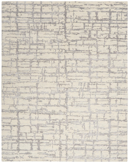 Cream area rug with a subtle textured gray grid pattern in a modern abstract style.