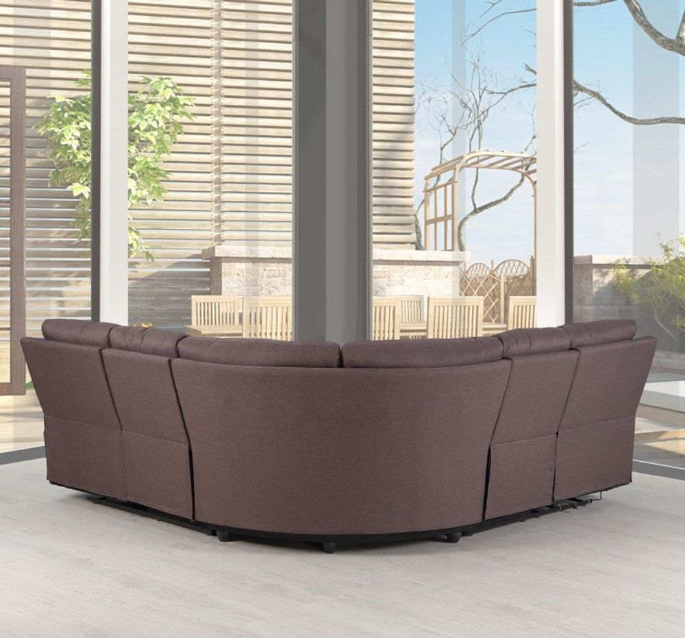 Brown curved fabric sectional sofa in a bright modern living room with floor-to-ceiling windows.