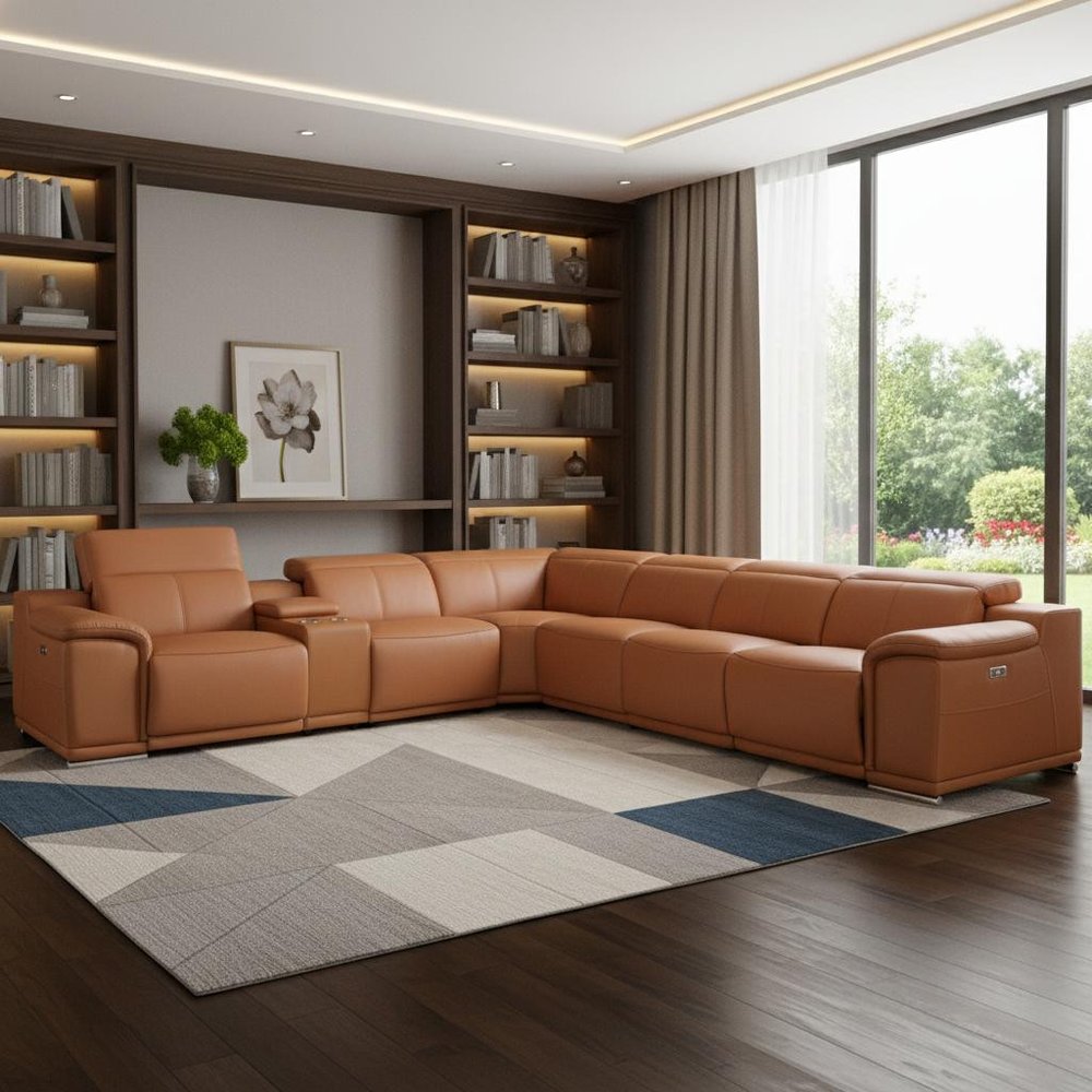 Camel leather power-reclining U-shaped seven-piece corner sectional with console in a modern living room, with dark wood shelves and a geometric gray-blue rug.