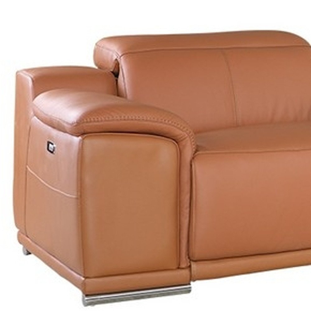Caramel brown leather sofa with rounded armrest, smooth cushions and chrome legs; modern style.