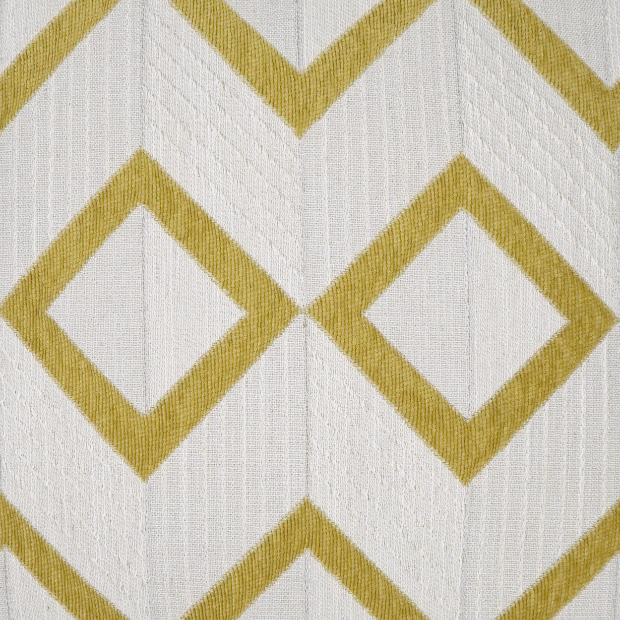 Citron geometric diamond-chevron pattern on fabric with a subtle vertical texture, 24" x 24" pillow.