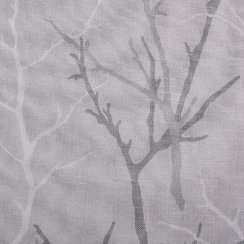 Grey fabric with abstract bare-tree silhouettes in dark and light grey, subtle woven texture.