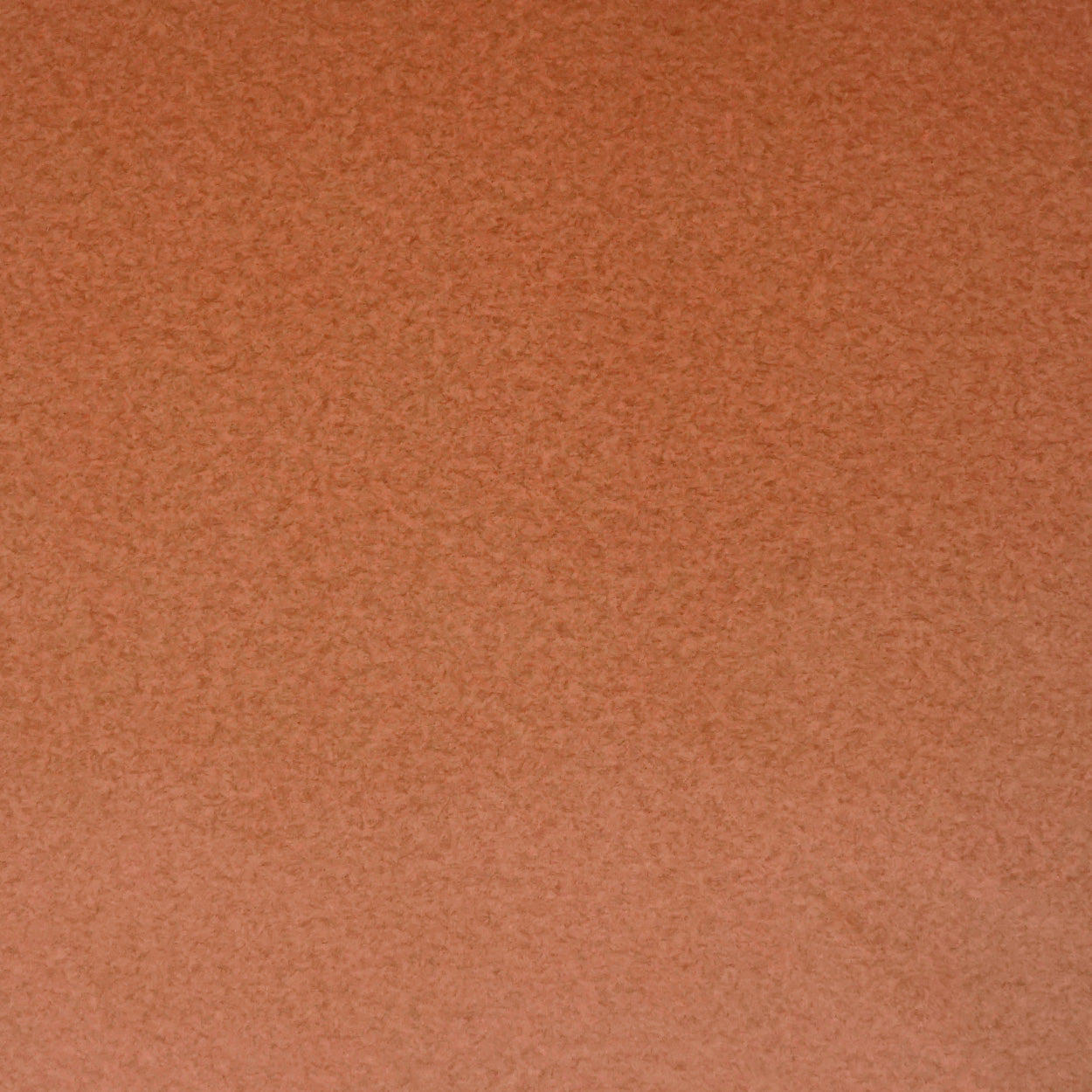 Rust-orange suede fabric swatch with soft nap