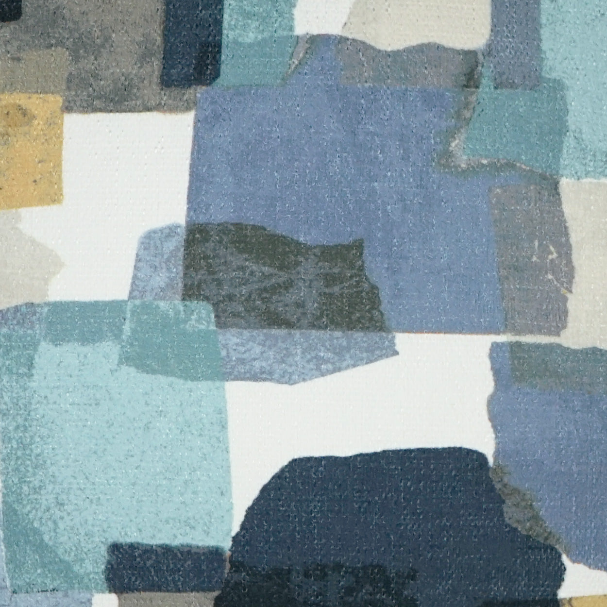 Pillow featuring a reef-inspired abstract pattern in blue and teal blocks with white gaps and a small yellow accent.