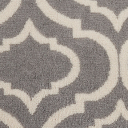 Grey rug with white Moroccan trellis pattern; soft woven texture, close-up.